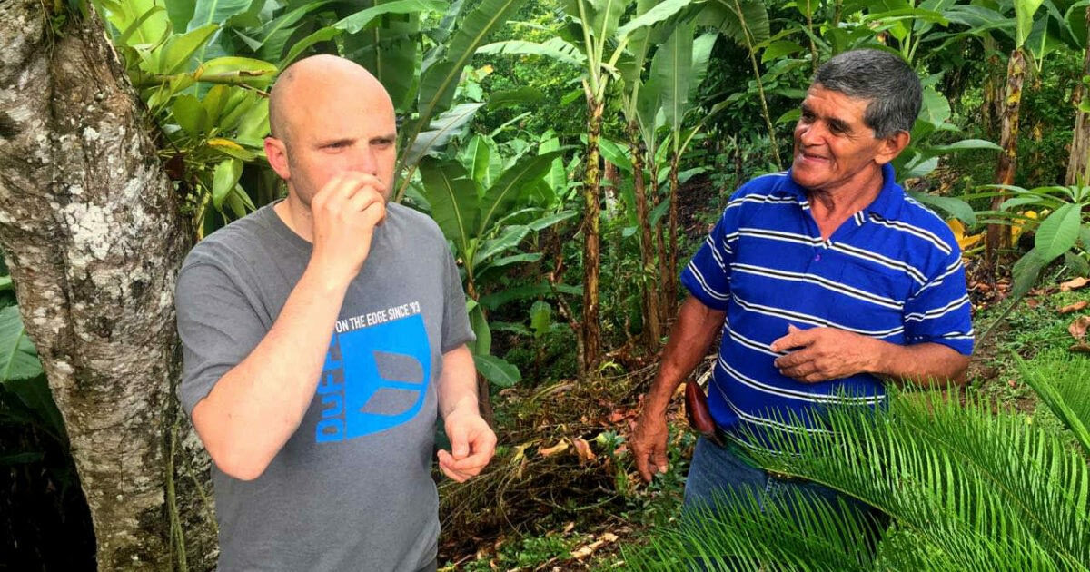 Man Smelling Coffee Beans With Local Guide
