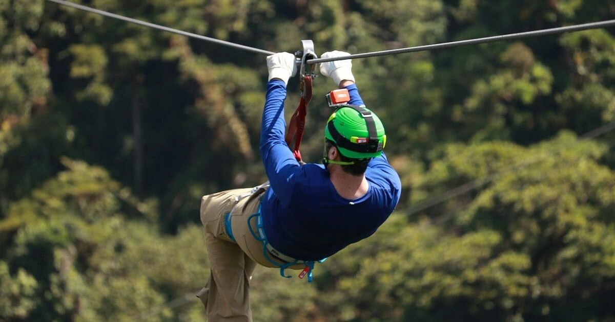 Top 5 Things to Do With the Family in Costa Rica 3 Man ziplining with trees below