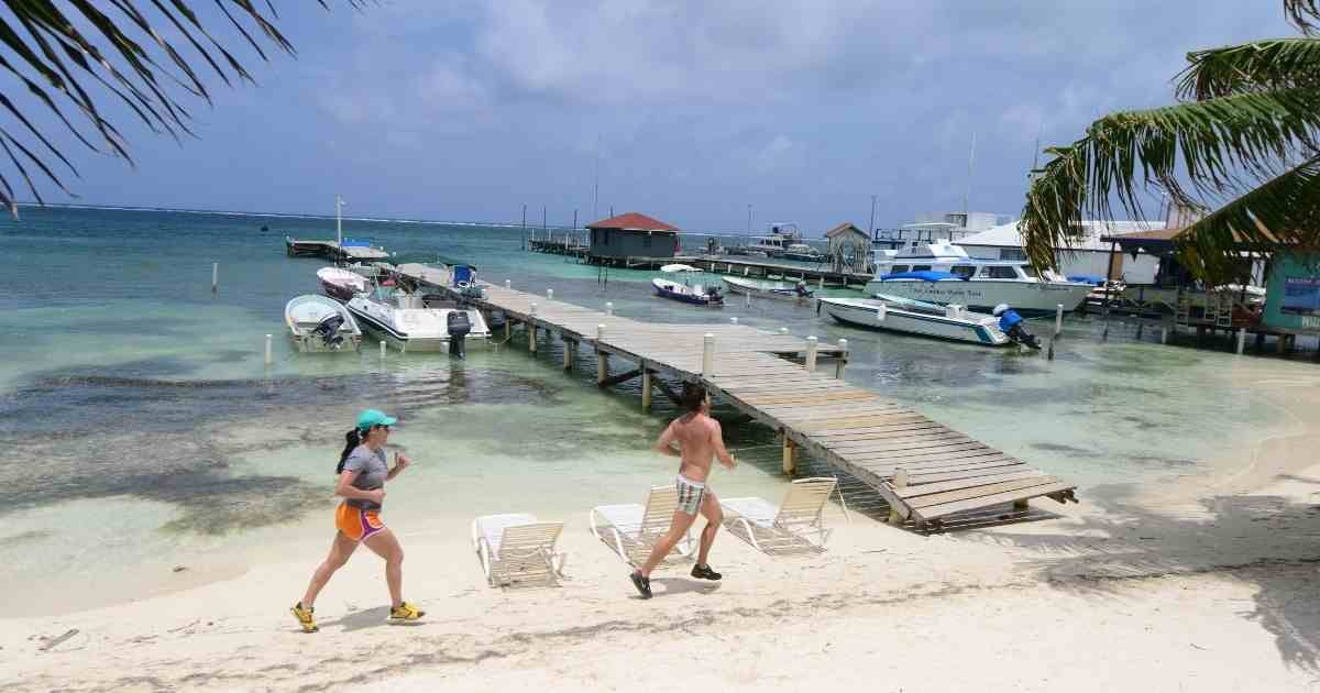 Why Visit Belize: Central America’s Hidden Gem 4 People jogging on the beach in Belize