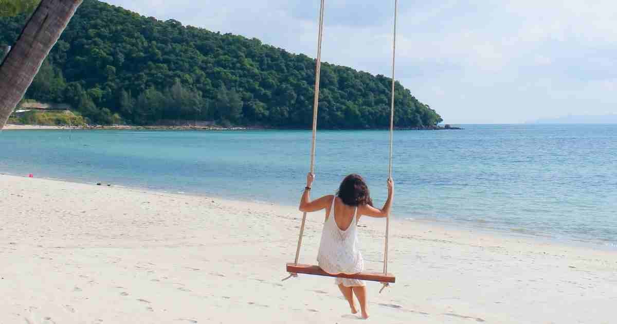 Are multi-generational holidays the future of family travel? 6 woman sitting on a beach swing in thailand